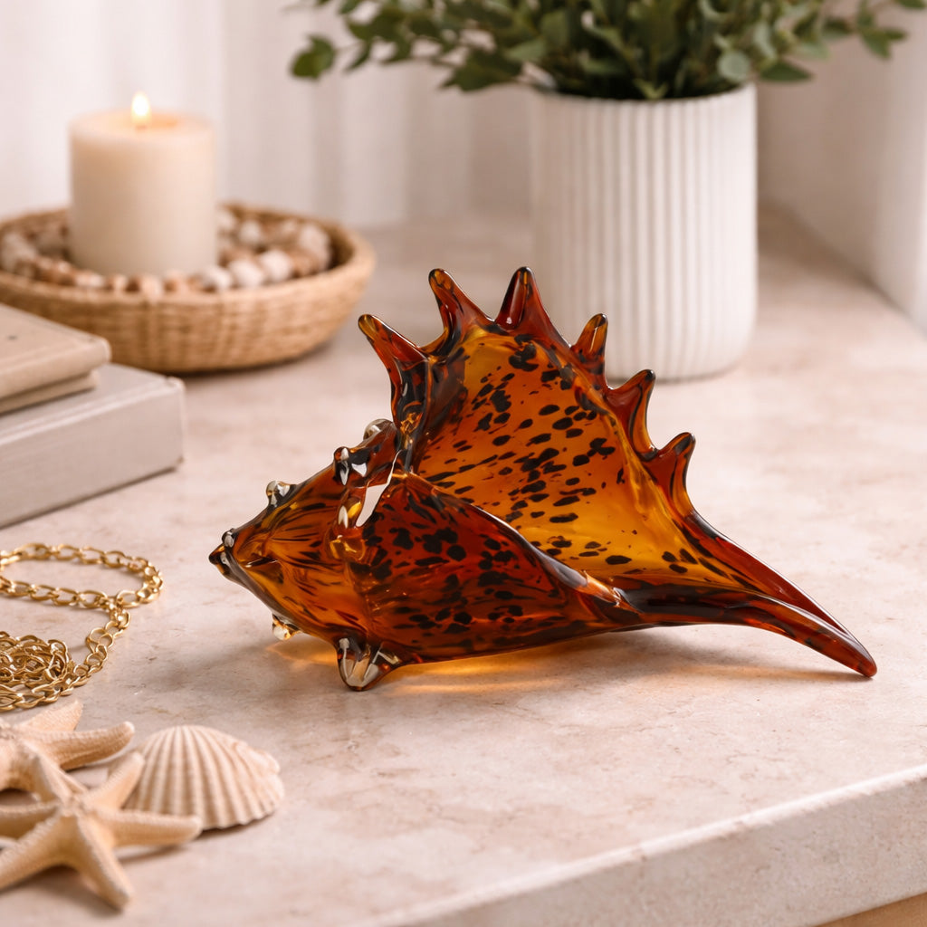 Original et audacieux, ce coquillage décoratif en verre motif léopard apporte une touche glamour et contemporaine à votre intérieur. Son design inspiré de l’univers marin, associé au motif léopard tendance, en fait un objet décoratif fort qui attire immédiatement le regard.